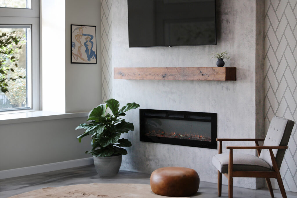 Modern living space featuring a floating reclaimed wood shelf mounted above a fireplace, juxtaposed with a contemporary gray textured wall and stylish decor.